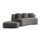 Small curved 2-3 seater sofa with low footstool and throw cushions