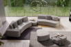 A custom design with two sofas joined by a pouffe and completed with an arm