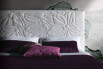 Detail of the upholstered headboard with embroidery with flower decoration