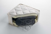 Detail of the mattress inner structure - traditional springs with layer of expanded polyurethane and fabric cover