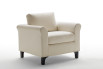 Greta is an armchair with solid wood feet and rounded.